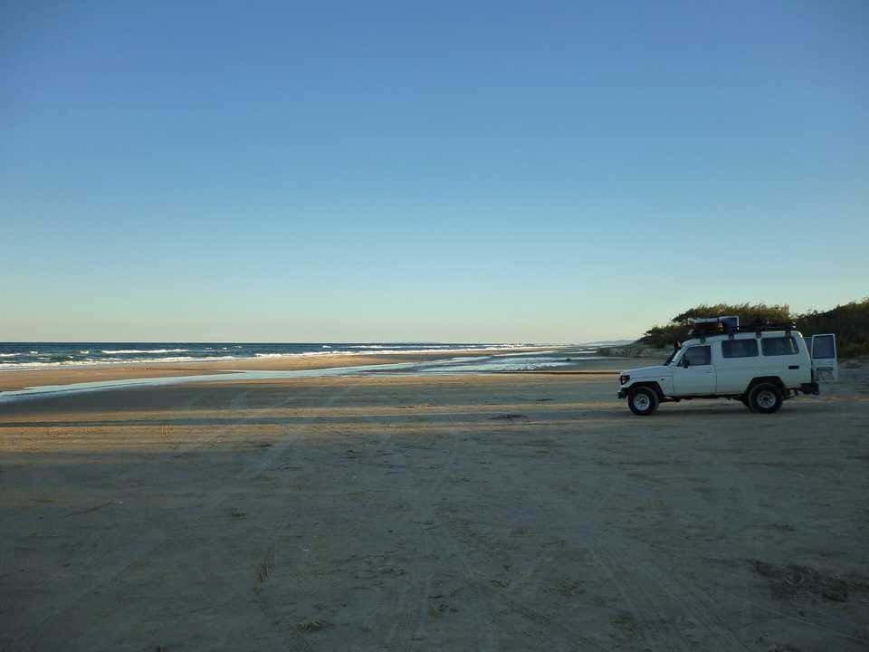 A four-wheel drive on the beach at K'gari (Fraser Island)