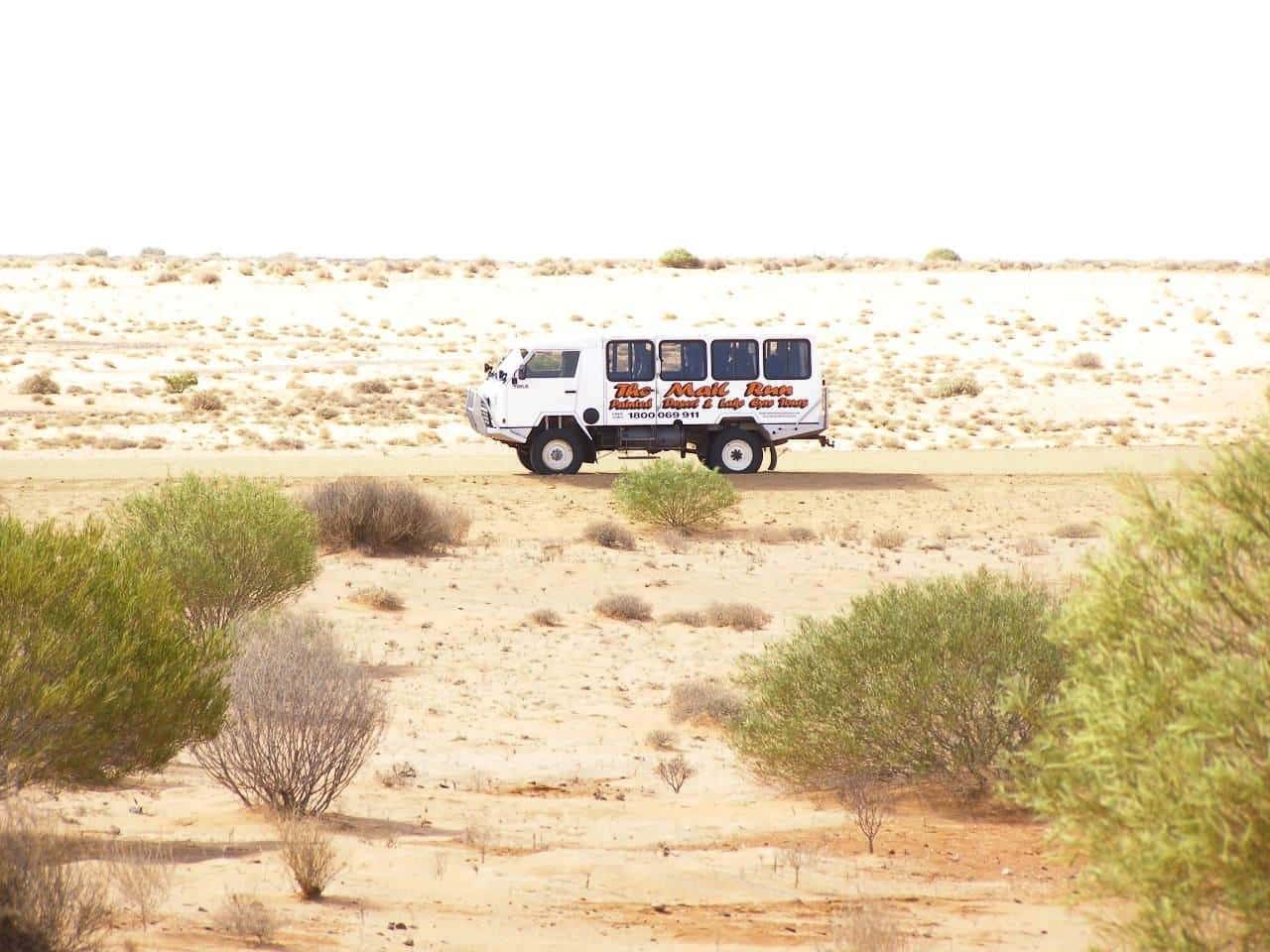 A four-wheel-drive mail truck on an outback track